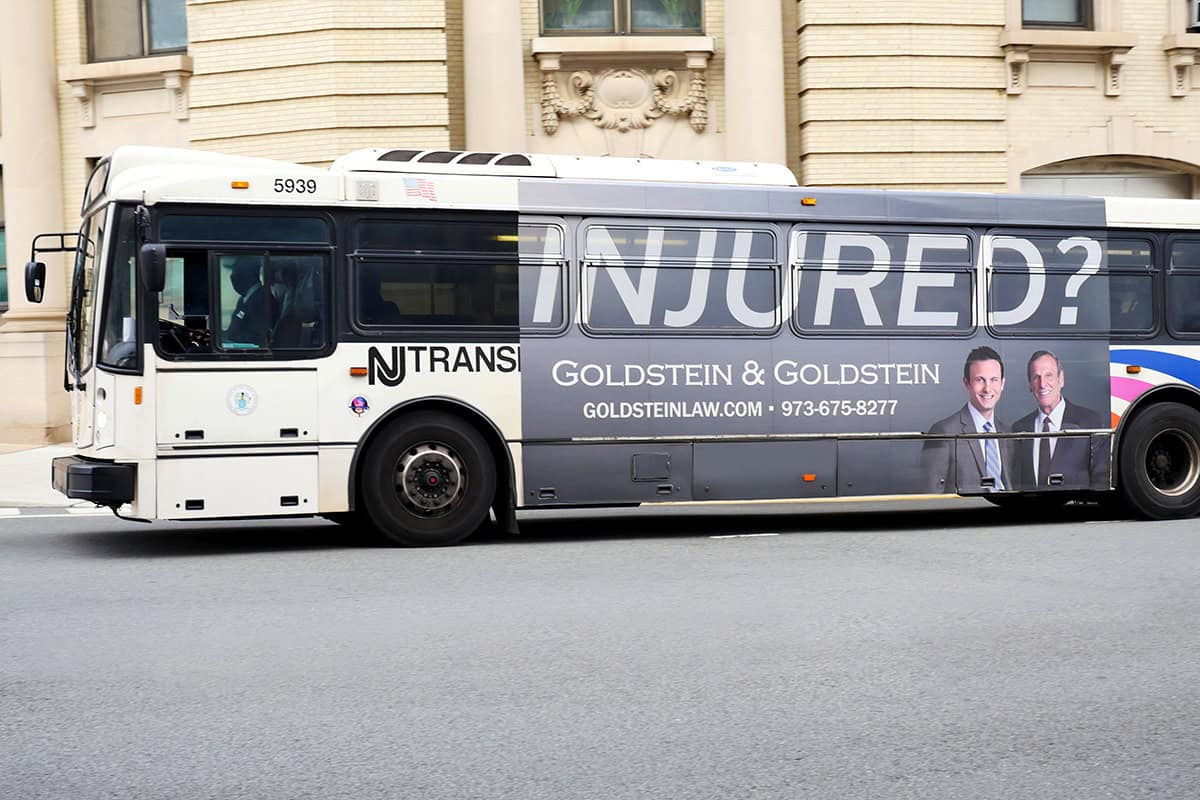 Injured bus advertisement for Goldstein & Goldstein law firm in New York City.