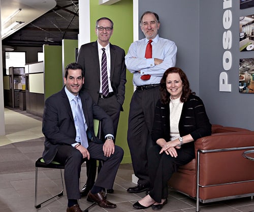 Marketing photo of four business professionals in office setting